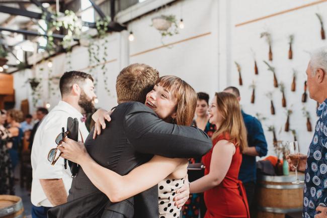 People hugging during a party at Cleaver St Event Space with Perth events photographer