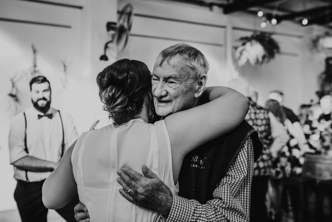 Black and white image of people hugging during a party at Cleaver St Event Space with Perth events photographer
