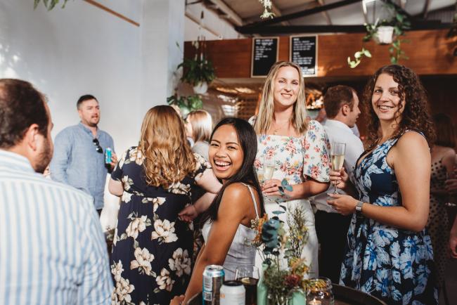 Woman laughing during a party at Cleaver St Event Space with Perth events photographer