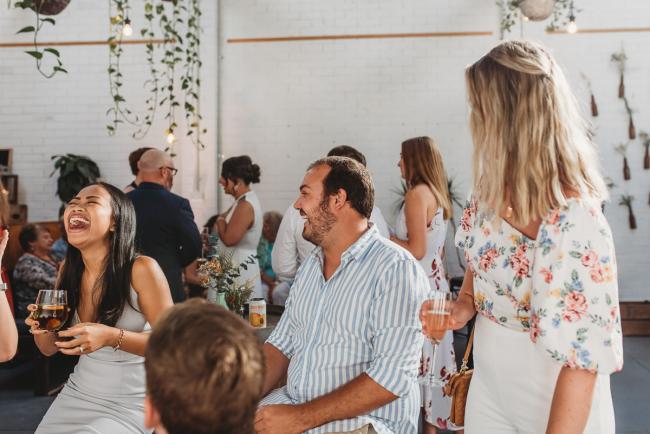 Woman laughing during a party at Cleaver St Event Space with Perth events photographer