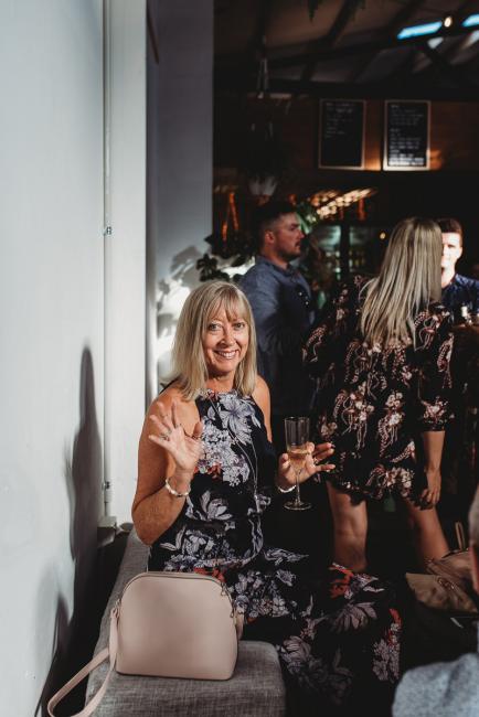 Woman waving at camera during a party at Cleaver St Event Space with Perth events photographer