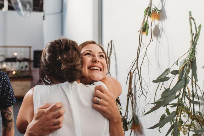 Women hugging during a party at Cleaver St Event Space with Perth events photographer