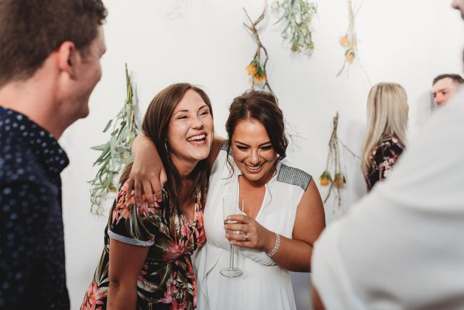 Women laughing during a party at Cleaver St Event Space with Perth events photographer