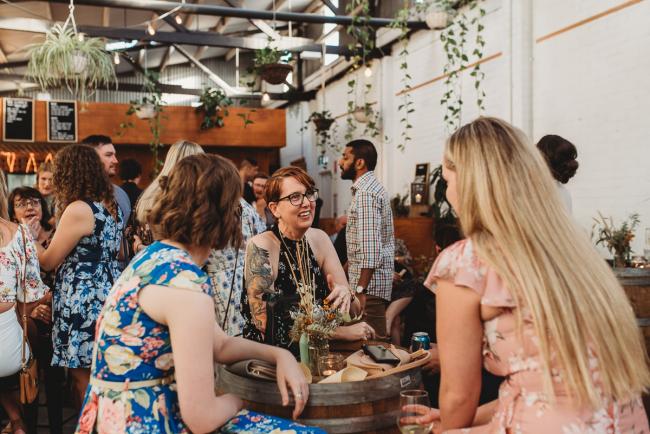 People sitting around bar table during a party at Cleaver St Event Space with Perth events photographer