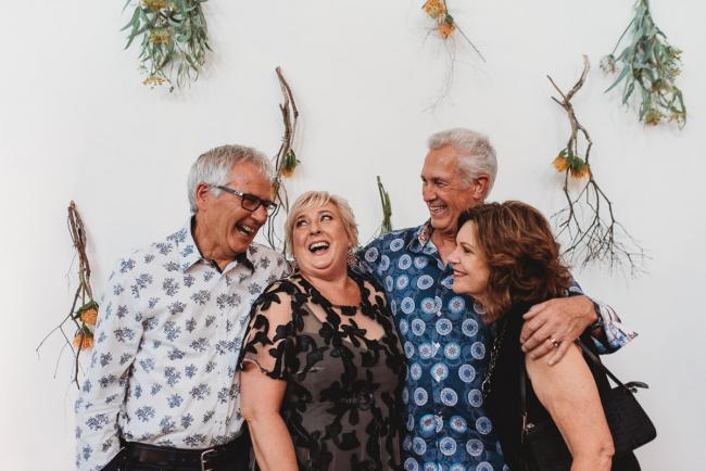 Group of four laughing during a party at Cleaver St Event Space with Perth events photographer