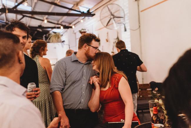 Man kissing womans head during a party at Cleaver St Event Space with Perth events photographer