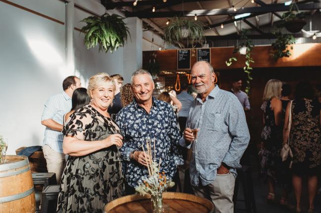 Group of three smiling at the camera during a party at Cleaver St Event Space with Perth events photographer