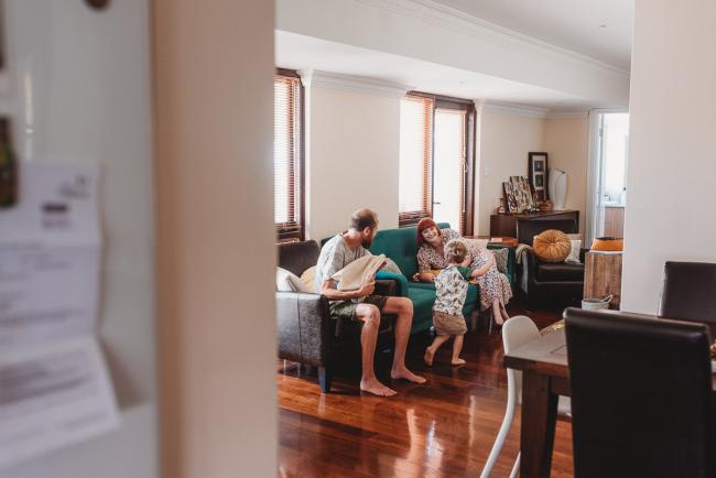 Family of four playing during in-home Perth newborn lifestyle photography session