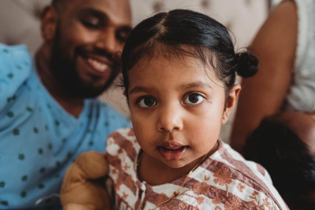 Little girl looking at the camera with in-home Perth lifestyle newborn photographer