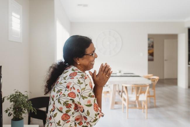 Grandmother smiling with in-home Perth lifestyle newborn photographer