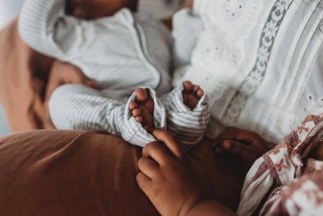 Little girl touching baby brother's toes with in-home Perth lifestyle newborn photographer
