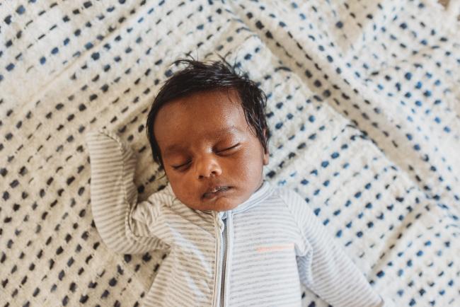 Newborn baby on blanket with in-home Perth lifestyle newborn photographer