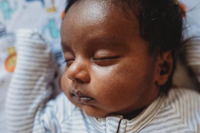 Close up of newborn baby's face with in-home Perth lifestyle newborn photographer