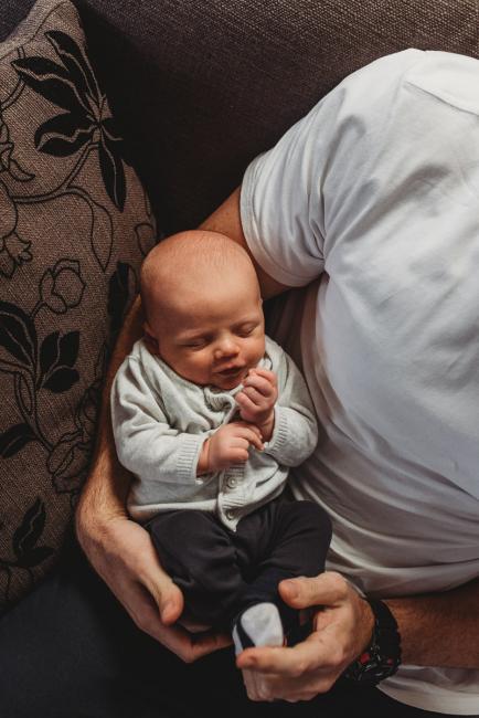 Baby sleeping in dad's arms with Perth Newborn photographer Alana Prosper Photography