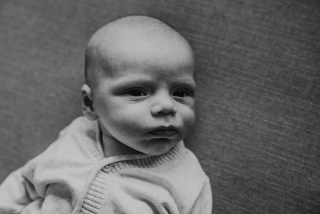 Black and white image of baby's face with Perth Newborn photographer Alana Prosper Photography