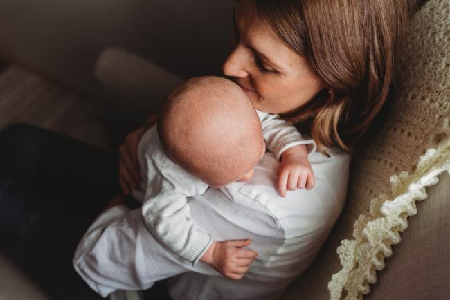 Baby on mother's shoulder with Perth newborn lifestyle photographer Alana Prosper Photography