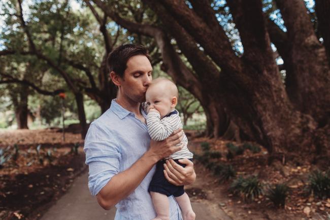 Father kissing baby during extended family session at Hyde Park with Perth family photographer Alana Prosper Photography