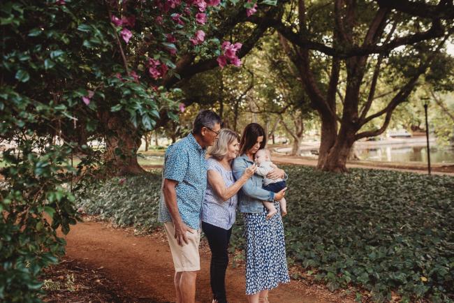 Baby sleeping on mother with grandparents during extended family session at Hyde Park with Perth family photographer Alana Prosper Photography