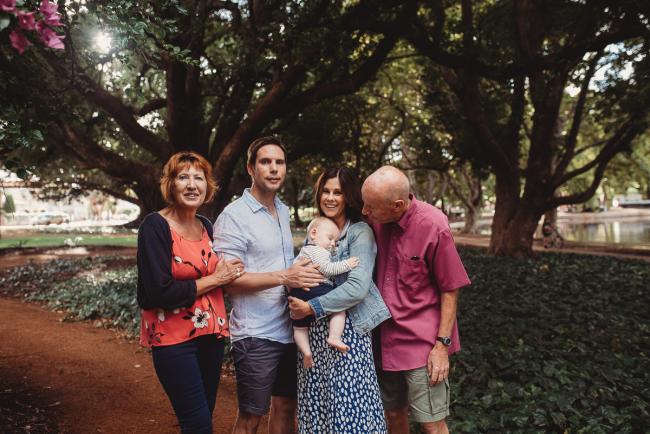 Baby with parents and grandparents during extended family session at Hyde Park with Perth family photographer Alana Prosper Photography