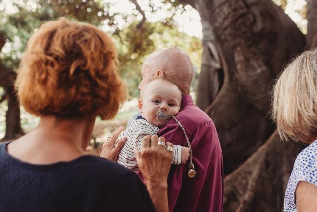 Grandfather holding baby over his shoulder with dummy in his mouth during extended family session at Hyde Park with Perth family photographer Alana Prosper Photography