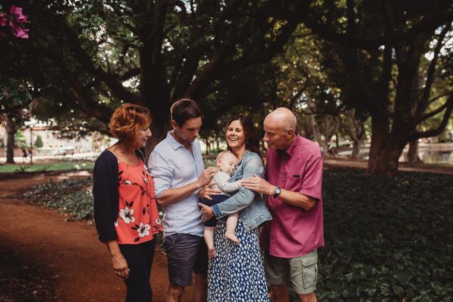 Baby with parents and grandparents during extended family session at Hyde Park with Perth family photographer Alana Prosper Photography