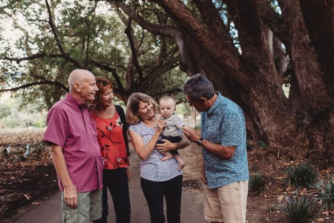 Baby with two sets of grandparents during extended family session at Hyde Park with Perth family photographer Alana Prosper Photography