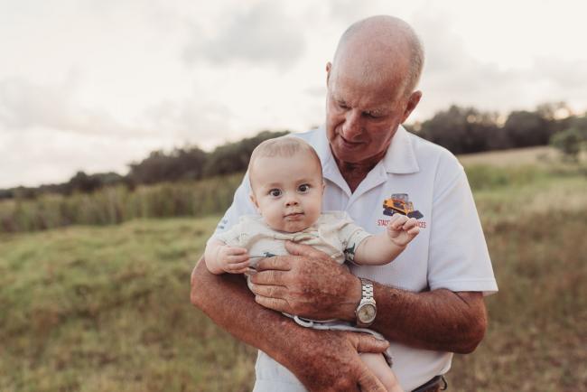 Baby being held by grandfather with Perth Family Photographer Alana Prosper Photography at Perry's Paddock