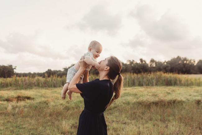 Mother lifting baby in the air with Perth Family Photographer Alana Prosper Photography at Perry's Paddock