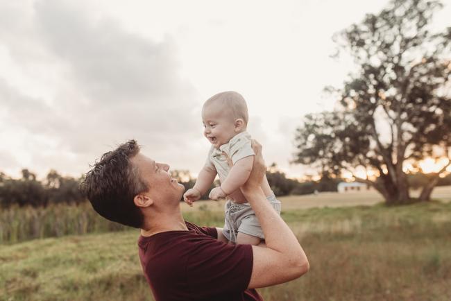 Father and baby smiling at each other with Perth Family Photographer Alana Prosper Photography at Perry's Paddock
