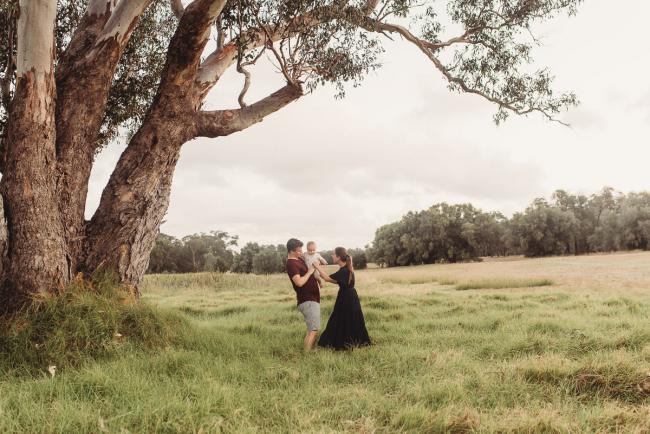 Parents under tree with baby with Perth Family Photographer Alana Prosper Photography at Perry's Paddock