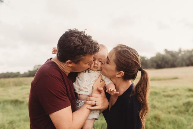 Parents kissing baby with Perth Family Photographer Alana Prosper Photography at Perry's Paddock