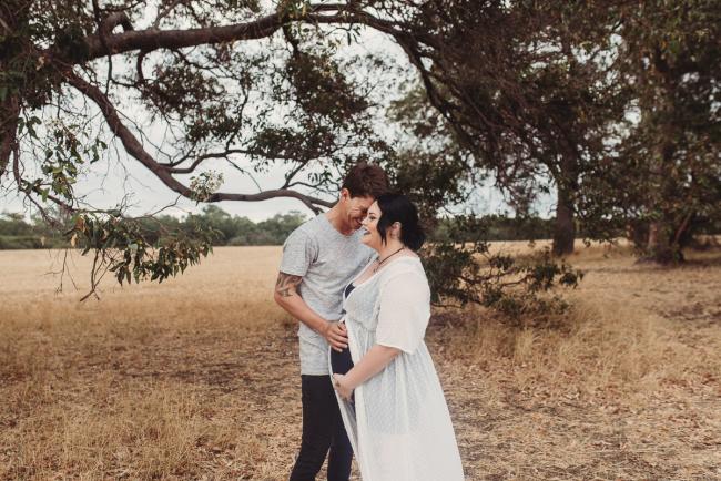 Pregnant woman and partner with Perth maternity photographer at Perry's Paddock