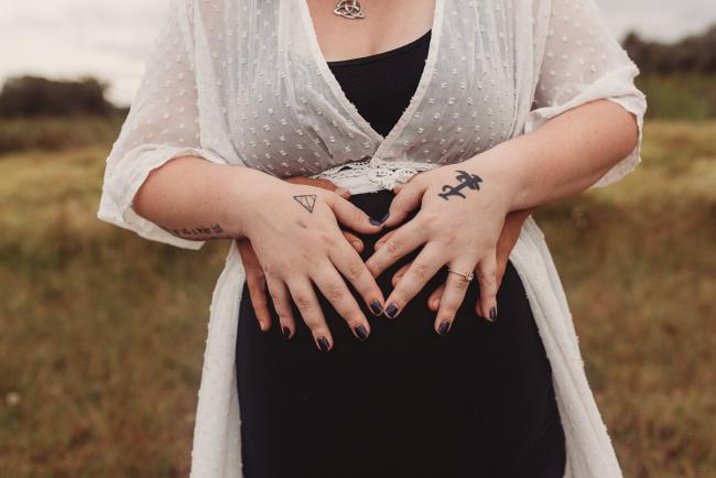 Close up of hands on pregnant tummy with Perth maternity photographer at Perry's Paddock