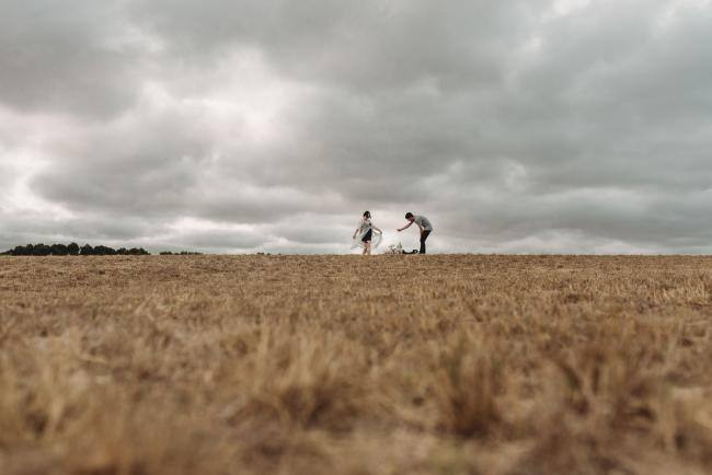 Couple playing with dogs with Perth maternity photographer at Perry's Paddock