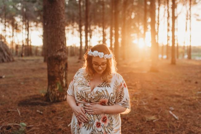woman looking down at The Pines with Perth maternity photographer Alana Prosper Photography