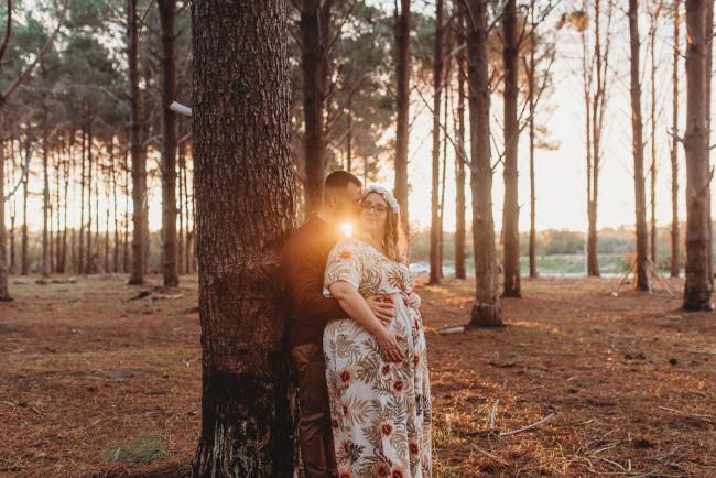 Couple leaning against a tree at The Pines with Perth maternity photographer Alana Prosper Photography