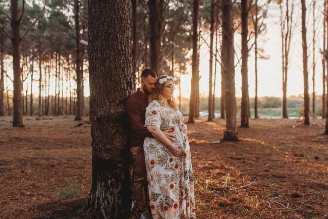 Couple leaning against a tree at The Pines with Perth maternity photographer Alana Prosper Photography