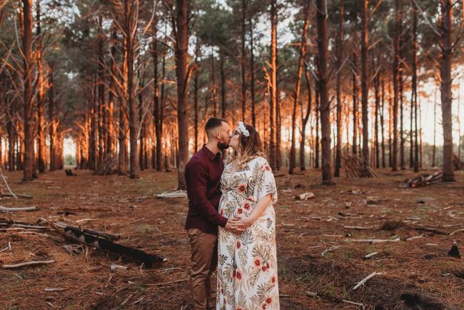 Couple kissing at The Pines with Perth maternity photographer Alana Prosper Photography