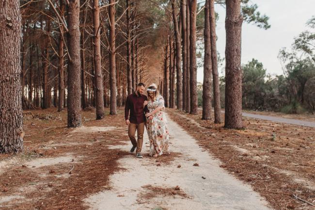 Couple walking and hugging arms at The Pines with Perth maternity photographer Alana Prosper Photography