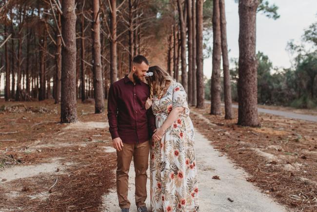 Woman leaning against man at The Pines with Perth maternity photographer Alana Prosper Photography