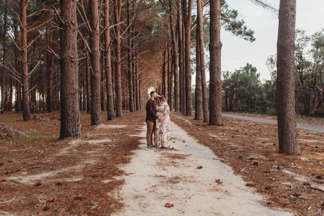 Man kissing woman forehead at The Pines with Perth maternity photographer Alana Prosper Photography