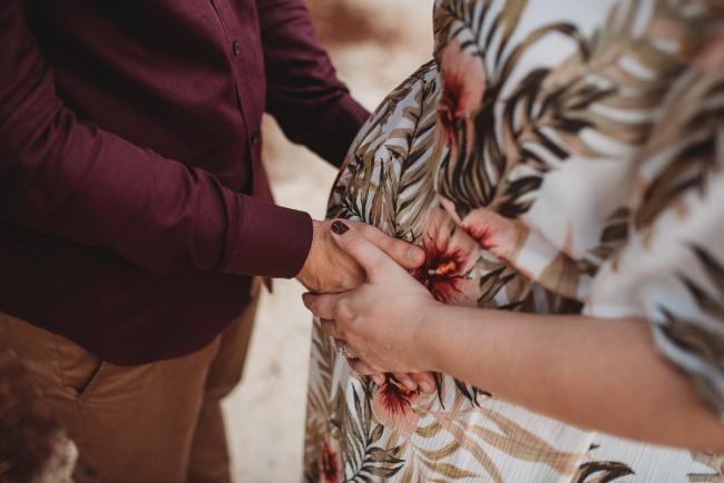 Close up of hands on pregnant tummy with Perth maternity photographer at The Pines