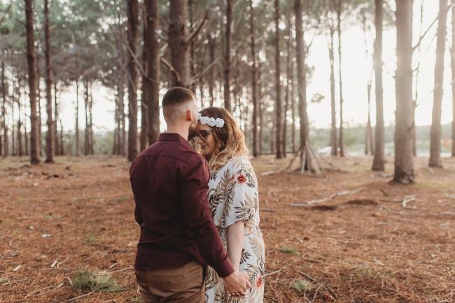 Man kissing woman's forehead at The Pines with Perth maternity photographer Alana Prosper Photography