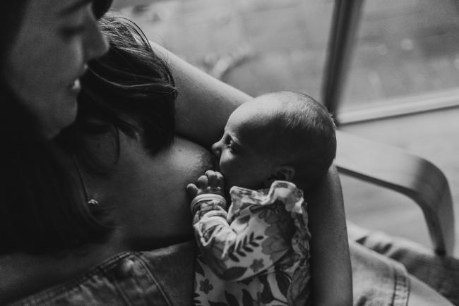 black and white image of baby breastfeeding with Perth newborn lifestyle photographer Alana Prosper Photography
