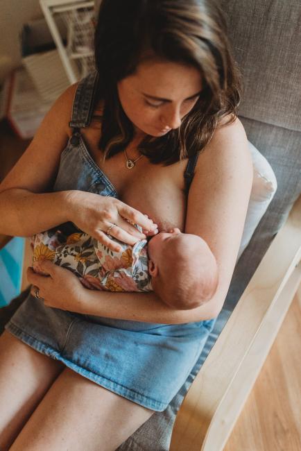 Mother breastfeeding with Perth newborn lifestyle photographer Alana Prosper Photography