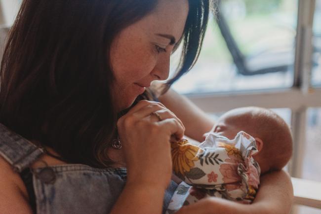mother kissing baby's hand with Perth newborn photographer Alana Prosper Photography