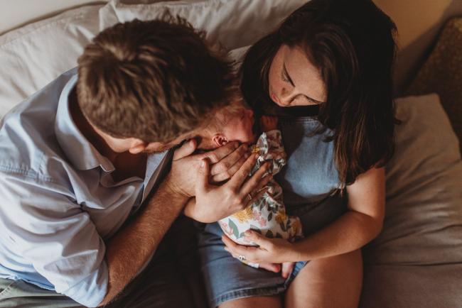 parents holding newborn baby with Perth newborn lifestyle photographer Alana Prosper Photography