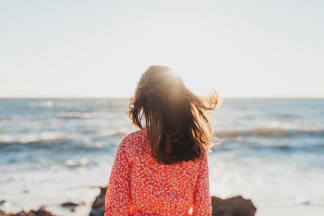 little girl looking at ocean at the beach with Perth family photographer Alana Prosper Photography at Burns Beach