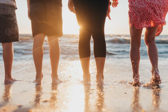 four kids legs and feet in the water at the beach with Perth family photographer Alana Prosper Photography at Burns Beach