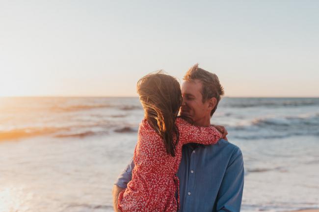 dad holding daughter with Perth family photographer Alana Prosper Photography at Burns Beach